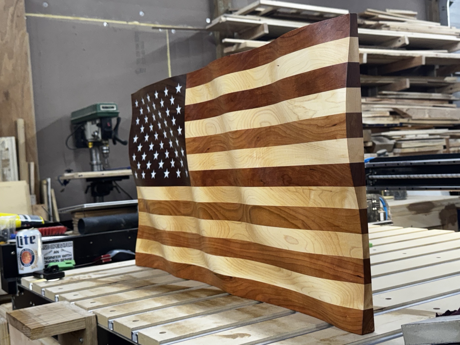 Angled shop photograph showing the flag's dimensional carved waves and thick edge